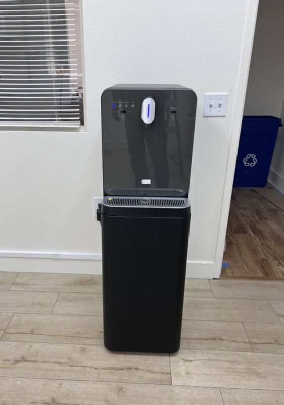 Bottleless water cooler installed in a commercial office near a hallway