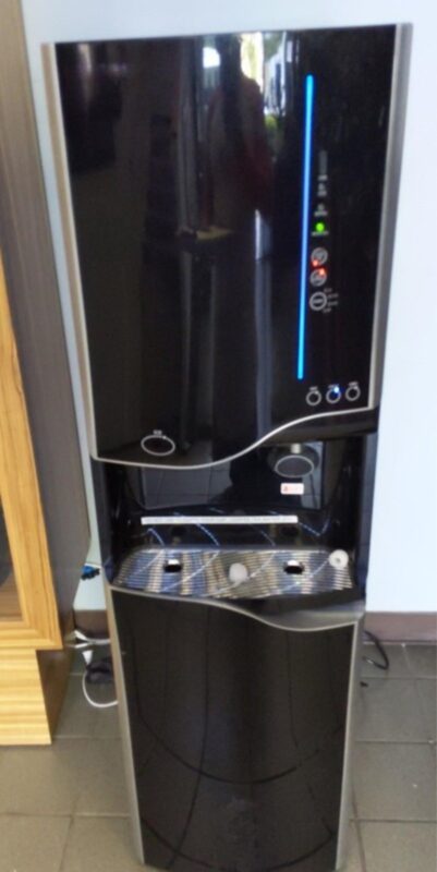 Bottleless water and ice cooler installed in an office lobby