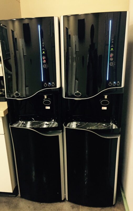 Two bottleless water and ice machines installed in an office breakroom