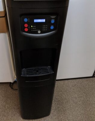 Bottleless point-of-use water cooler installed in an office