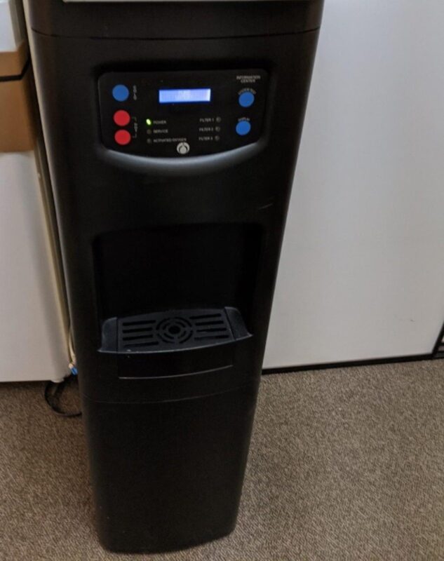 Bottleless point-of-use water cooler installed in an office